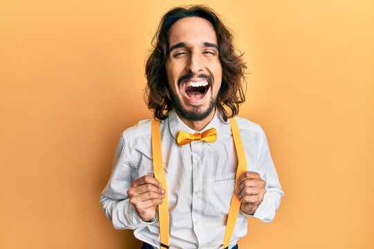 Young hispanic man wearing hipster elegant look smiling and laughing hard out loud because funny crazy joke.