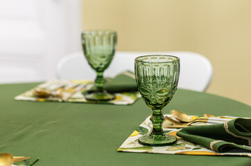 Dinner table setting idea with textured green glass goblets.