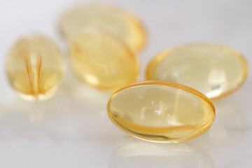 Capsules over  white background. Capsules vitamins fish fat pills omega 3 or hyaluronic acid...