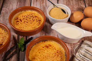 Chef cooks creme brulee with gas burner, dessert in the home kitchen, Cooking at home, professionals for food blog. High quality photo