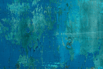 Wooden backdrop with copy space. Blue colored peeling off old painted surface with a many scratches and scrapes.
