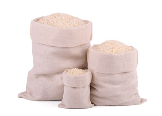 Three burlap sack bags with rice isolated on white background