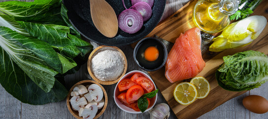 Fresh food ingredients prepared for cooking on a kitchen table