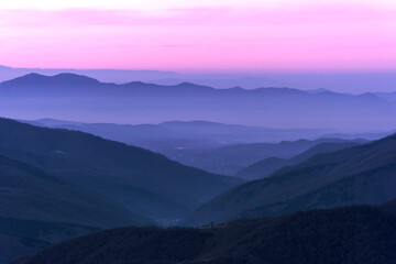 Fototapeta na wymiar Sunrise in pink colors of the sun in the mountains