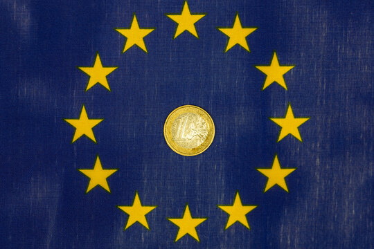 €1 coin in the middle of the European Union flag, Economic and financial concept