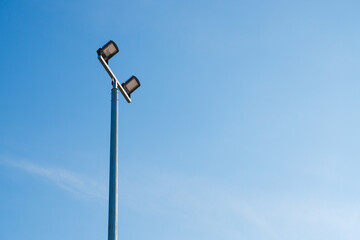 Modern park LED luminaire on a tall metal mast.