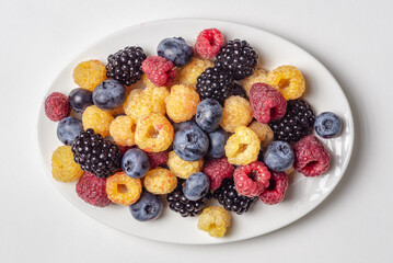 Assorted fresh berries on a white plate