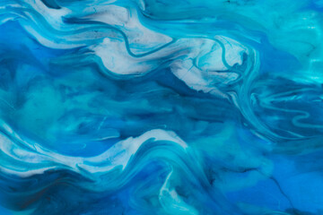 Fototapeta na wymiar Epoxy resin art. Texture of blue and white paint. Fluid art, kintsugi. Close up