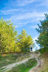 Obraz premium tourist with backpack walking along on the road in mountains