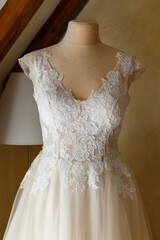 Fototapeta na wymiar Wedding dress with lace wearing on mannequin.