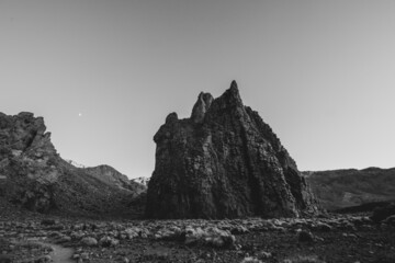 Fototapeta na wymiar Black and white scenery of a barren volcanic landscape with sharp rocks and desert. Panorama of the island Tenerife, Canary Islands, with the Teide volcano and its lava flows..Wallpaper and nature