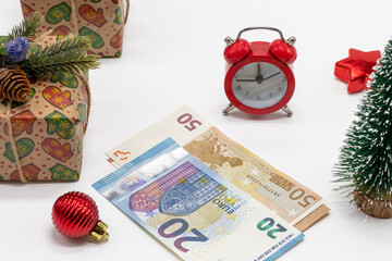 Christmas background with gift boxes, alarm clock and 50 and 20 euro bills. Celebrating Christmas, congratulations, preparing for the winter holidays. It's time to buy gifts.  top view, flat lay.
