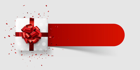 White polka dot gift box with red bow on red line.