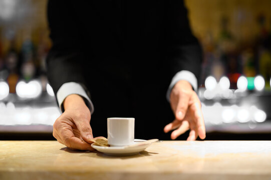 Closeup of a barman serving you a coffee