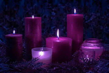 Obraz na płótnie Canvas candle burn black background light a lot violet velvet purple blue