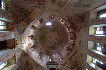 The dome of an old ruined abandoned pro-Orthodox church in Russia. Bottom view. Boarded-up windows....