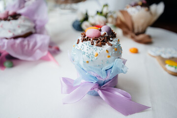 Beautiful Easter cakes with Easter eggs on a decorated light table. Bright Easter holiday.