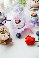 Beautiful Easter cakes with Easter eggs on a decorated light table. Bright Easter holiday.