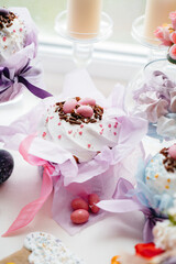 Beautiful Easter cakes with Easter eggs on a decorated light table. Bright Easter holiday.