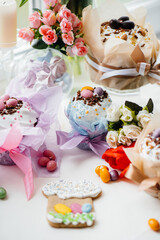 Beautiful Easter cakes with Easter eggs on a decorated light table. Bright Easter holiday.