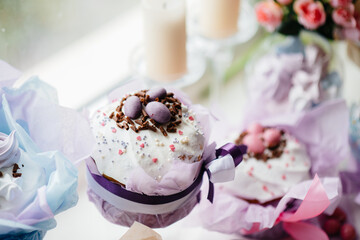 Beautiful Easter cakes with Easter eggs on a decorated light table. Bright Easter holiday.