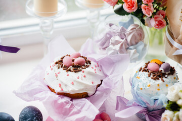 Beautiful Easter cakes with Easter eggs on a decorated light table. Bright Easter holiday.