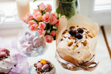 Beautiful Easter cakes with Easter eggs on a decorated light table. Bright Easter holiday.