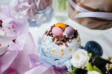 Beautiful Easter cakes with Easter eggs on a decorated light table. Bright Easter holiday.