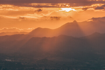 Beautiful sunset in Costa Blanca, Spain. View from Torre Aguilo in Villajoyosa. Dark silhouette of mountains on sunset background