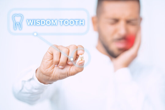 Man with extracted wisdom tooth. Man after wisdom teeth removal surgery. Wisdom teeth pain