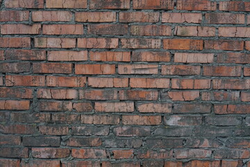 Old brick wall. Red brick wall. Red brick texture. The wall and brick were pretty beaten by time and rain.