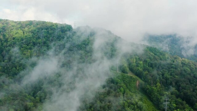Caucasus Mountains, Akhun mountain range. Navalishinsky Canyon (White rocks). The valley of the Bolshaya Khosta River in fog. Aerial view.