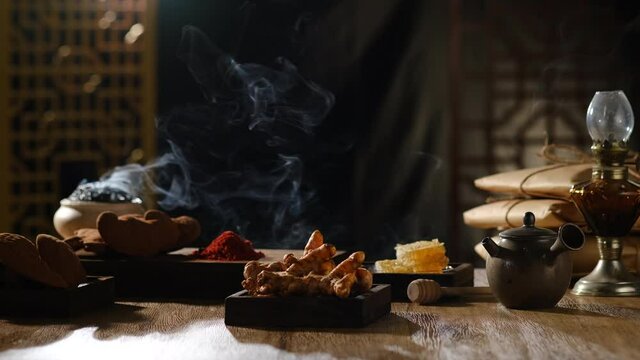Lighting and smoke with turmeric ganoderma pack of medicine in a table , for chinese traditional medicine advertising , front view	
