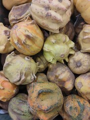 ripe decorative pumpkin crown in a basket on the supermarket counter