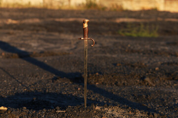 Vintage bayonet knife in the ground