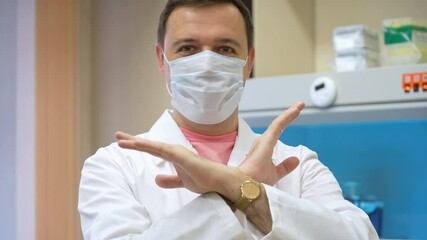 Male chemical laboratory researcher says "no" and shakes his head in a biomedical laboratory. A scientist standing in a vintage-style laboratory and turning his head in disagreement - Powered by Adobe