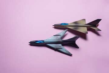 Fighter plane toys on the pink background.