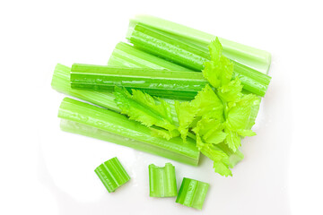 Fresh Chopped Celery Sticks and Slices with Leaves and Water Drops Isolated on White Background. Vegan and Vegetarian Culture. Raw Food. Healthy Diet with Negative Calorie Content