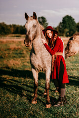 Dziewczyna głaszcząca konia - obrazy, fototapety, plakaty