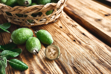 Fresh green feijoa fruits on wooden surface. Acca sellowiana berries of the guava family. Vitamin C, Healthy eating. Selective focus.