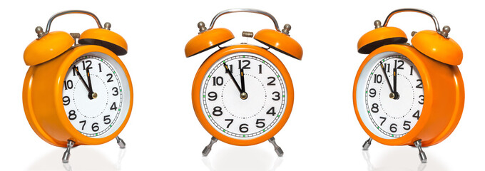 set of vintage orange alarm clocks isolated on white background. Countdown to midnight on clock face.