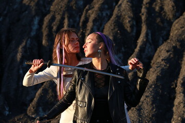 Obraz premium Two women fighting with swords near coal