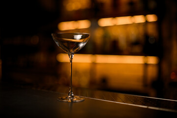focus on beautiful clean glass on a bar counter on a blurred background