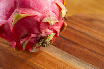 a pitaya fruit on a wooden table