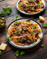 Pasta alla Norma with eggplant or aubergine, tomato, parmesan and basil. Healthy food