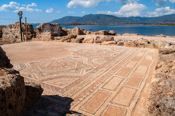 Excavations in Nora, Sardinia - old stone mosaic on the ground with remnants of walls - obrazy, fototapety, plakaty