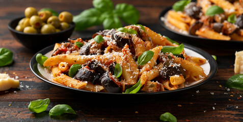 Pasta alla Norma with eggplant or aubergine, tomato, parmesan and basil. Healthy food
