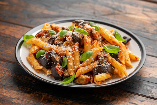 Pasta alla Norma with eggplant or aubergine, tomato, parmesan and basil. Healthy food