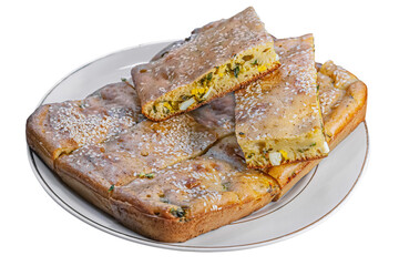 homemade pie with green onions and eggs on a white plate isolated on white