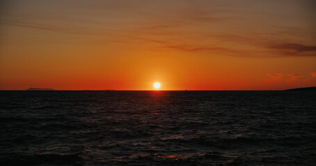 Sunset over the sea horizon.